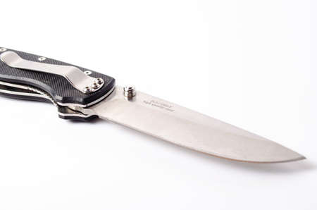 A folding knife with a black handle on a white background, open and closed. Paracord lanyard on the...