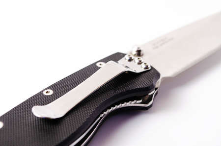 A folding knife with a black handle on a white background, open and closed. Paracord lanyard on the knife. Tactical folding knife in close-upの写真素材