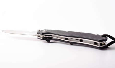 A folding knife with a black handle on a white background, open and closed. Paracord lanyard on the knife. Tactical folding knife in close-upの写真素材