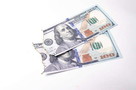 Burnt dollars. Burnt side view on white background banknotes in close-upの写真素材
