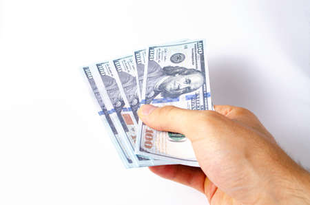 American dollars in a man's hand on a white background first person view gives