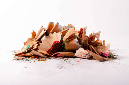 Shavings of red pencil in close-up on a white background. Pencil lead whole and broken on a white...