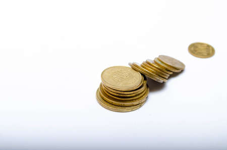 Ukrainian coins on a white background in close-up. Coins in a heap close-up, in the form of a...