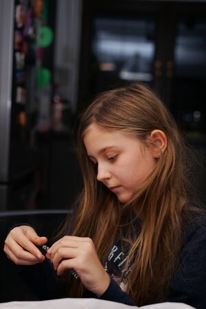 girl while playing - prepares an element of a handmade dollの写真素材