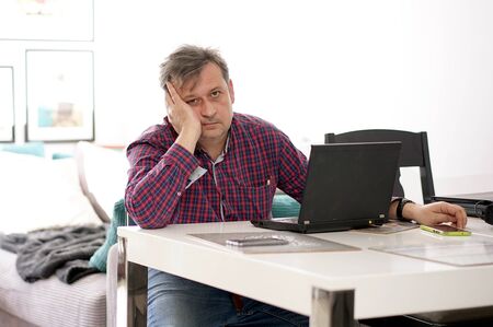 middle-aged man working remotely at home office
