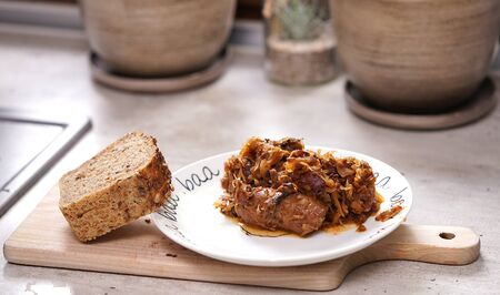 Bigos - a traditional Polish dish with bread on a plate