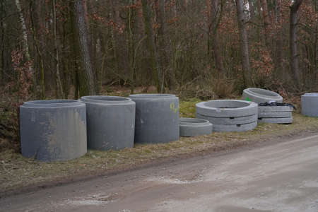 Concrete tube sewers on the road in the forest