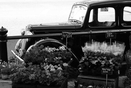Dorking, Surrey, United Kingdom, 25 April 2017: Flowers for Sale on Raised Boxes with a Austin Ruby Car Backgroundのeditorial素材