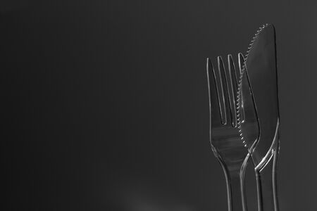 A Plastic Transparent Knife and Fork with a Sky Backgroundの写真素材