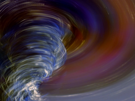 An Abstract Photo of a Tornado Showing the Eye of the Vortex on a Colourful Motion Background
