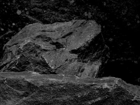 A Rough Textured Rock with Foreground Focus with a Stone Blurred Black and White Background .の写真素材