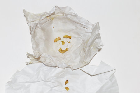 Small unknown Face Potato Chips on Stained Food Paper.の写真素材