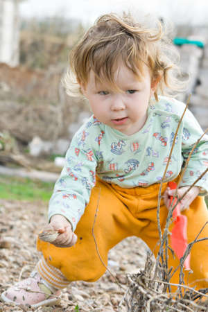 child plays with sand in the parkの写真素材