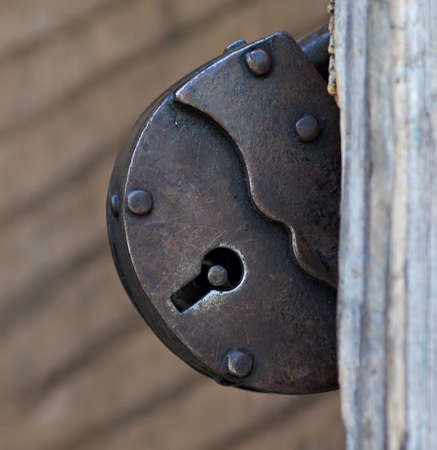 Old rusty metal lock of brown color. Closeup, macro.の写真素材