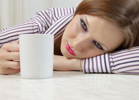 A beautiful girl is in a state of extreme intoxication after alcohol drinking.の写真素材