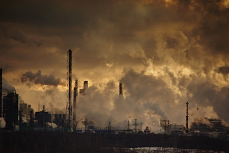 The plant emits smoke and smog from the pipes at sunset, pollutants enter the atmosphere. Environmental disaster. Harmful emissions into. Exhaust gases. Metallurgical industry against the sky.の写真素材