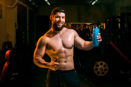 man in the gym drinking from the shaker