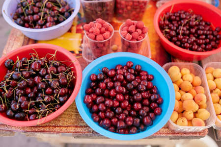 Sweet cherry, raspbeery and apricot on a farm market in the city. Fruits and vegetables at a farmers...