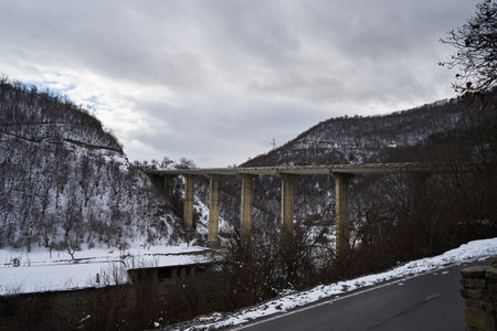 Viaduct bridge near ananuricastle complex on the Aragvi River in Georgia. Snowy winter scenery in the caucasus mountains.の写真素材