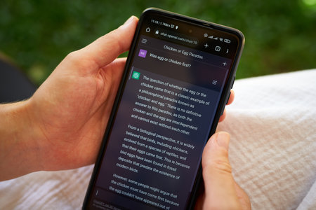 February 5, 2023, Mirissa, Sri Lanka. Using OpenAI chatGPT on phone. Woman chats with artificial intelligence. Person tests neural network language Mirissa online. Human talks to AI via GPT close-upのeditorial素材
