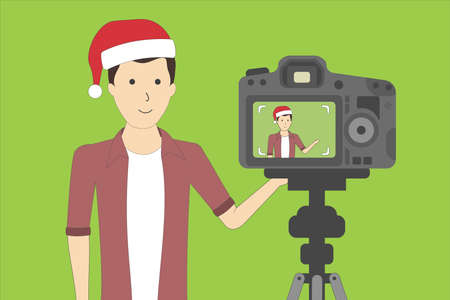 Christmas blog recording on chroma key background. Vlog. Video recording. Handsome boy in santa hat.のイラスト素材