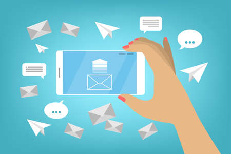 Hand holding mobile phone with envelope on the screen