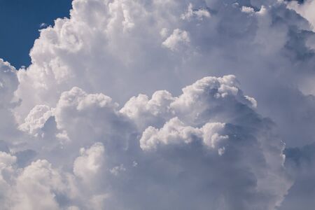 closeup big fluffy white clouds in the blue skyの写真素材