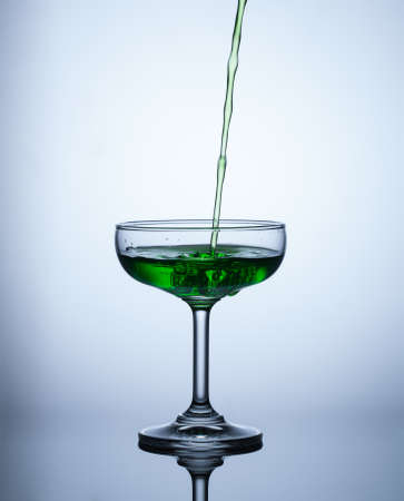 green water flows into the glass and makes bubbles,objectの写真素材