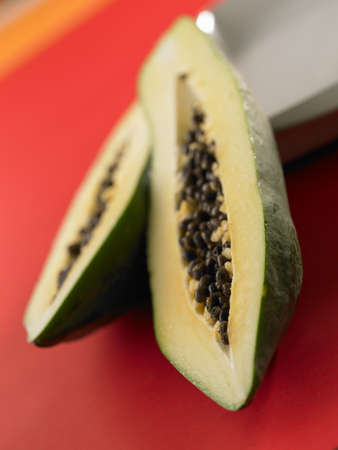 Green papaya on red backgroundの写真素材