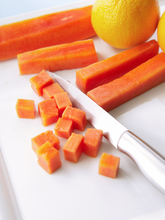 fresh carrot diced with orange on white plateの写真素材