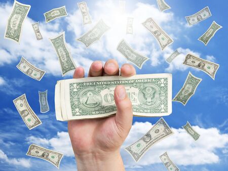 hand with dollar and falling moneyの写真素材