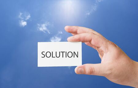 solution text on white card in human handの写真素材