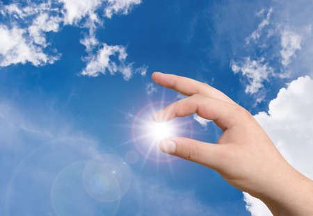 hand holding the sunの写真素材