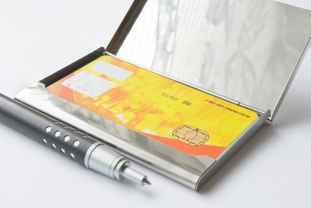 Credit card metallic holder with pen on whiteの写真素材