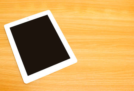 Tablet on wood backgroundの写真素材