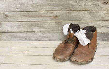 Still Life brown leather men's boots on wood backgroundの写真素材