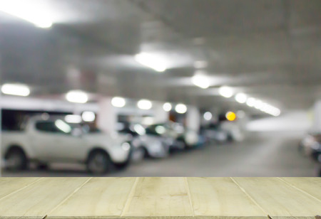 soft focus wooden table with blur cars parking