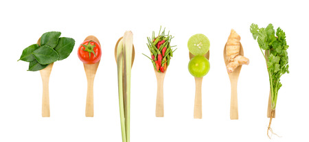 Flat lay of fresh Thai delicious spicy & sour Tom Yum dish's ingredients of lemon grass, cilantro, galangal, kaffir lime leaves, limes, spicy bird peppers & tomato isolated on white space backgroundの写真素材