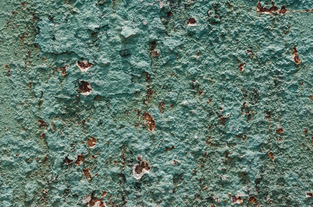 Grunge styled rusty old green and brown iron wall backgrounds of outdoor textured old damaged steel wall pattern surfaceの写真素材