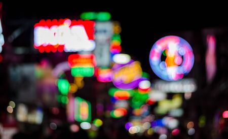 Blur bokeh background of bar light at night time in pub, club or entertainment street for text or graphic design effectの写真素材