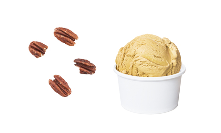 Butter Pecan Ice Cream in white cup and pieces of pecan nuts isolated on white background (clipping path included for each piece)の写真素材