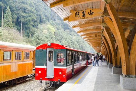 CHIAYI, Taiwan - Mar 10, 2012: Alishan National Scenic Area's railway station platform with passengers getting on to the trainのeditorial素材