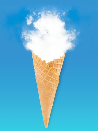 Empty or blank ice cream crispy wafer cone with soft white cloud vapour over blue sky and green background, summer conceptの写真素材