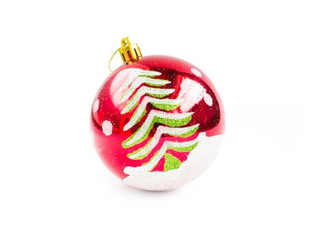 Christmas decorative red ball painted with white snow and green pine tree isolated on white background (clipping path included) for xmas tree decorationの写真素材