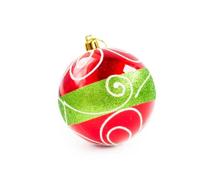 Christmas decorative red ball painted with white curved circle lines and green big line isolated on white background (clipping path included) for xmas tree decorationの写真素材