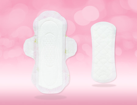 Sanitary napkin and pad (front side, close-up) in new, clean, thin and white features isolated on gradient pink background and bokeh (clipping path included) for menstrual period day on every monthの写真素材