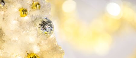 Christmas white tree with gold and silver balls ornament and blur light bokeh background for text decoration, insertion or xmas promotion product design display in special occasion or 2018 new year season timeの写真素材
