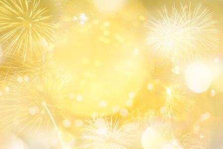 Gold glitter Christmas abstract background with light bokeh and fireworks for Xmas season decoration or new year party celebrationの写真素材