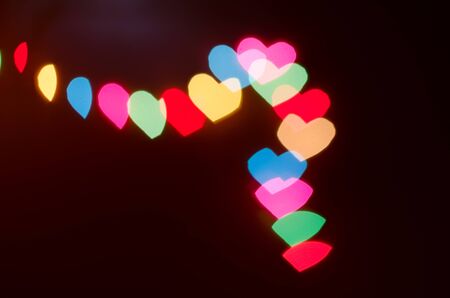 Christmas light in heart shape bokeh background for Xmas season decoration or new year party celebrationの写真素材