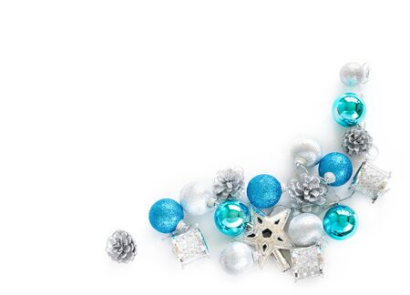 Christmas tree decorative ornaments of silver star, blue balls, pine cone and small drums over white background with copy space for winter Merry X'mas text insertion,   product decoration on new yearの写真素材